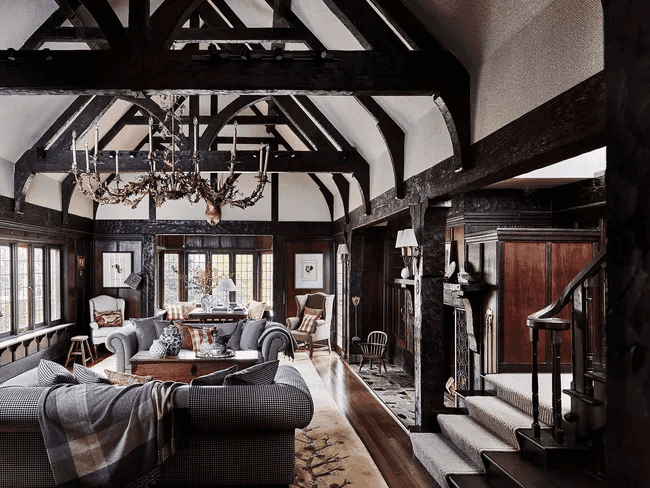 Dramatic Gothic interior design style showing dark moody walls, pointed arch motifs, and heavy wrought iron chandeliers
