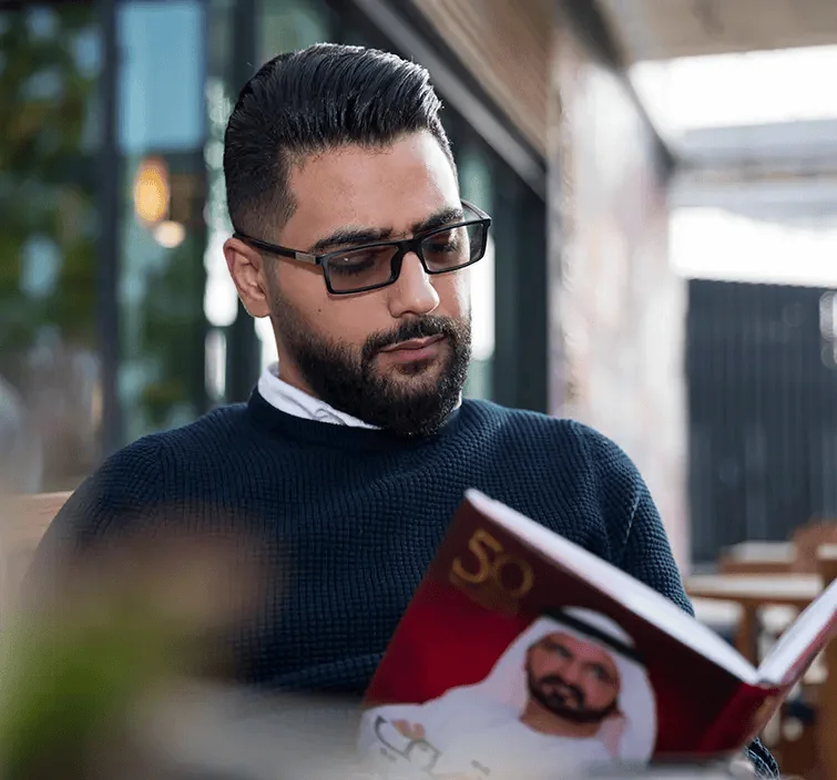 mohab ayoub interior designer in dubai reading a design magazine
